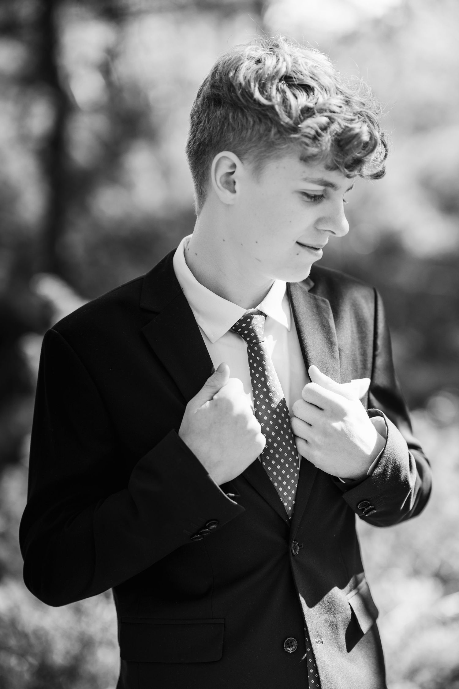 Black and white portrait series showing contemplative poses in formal attire.