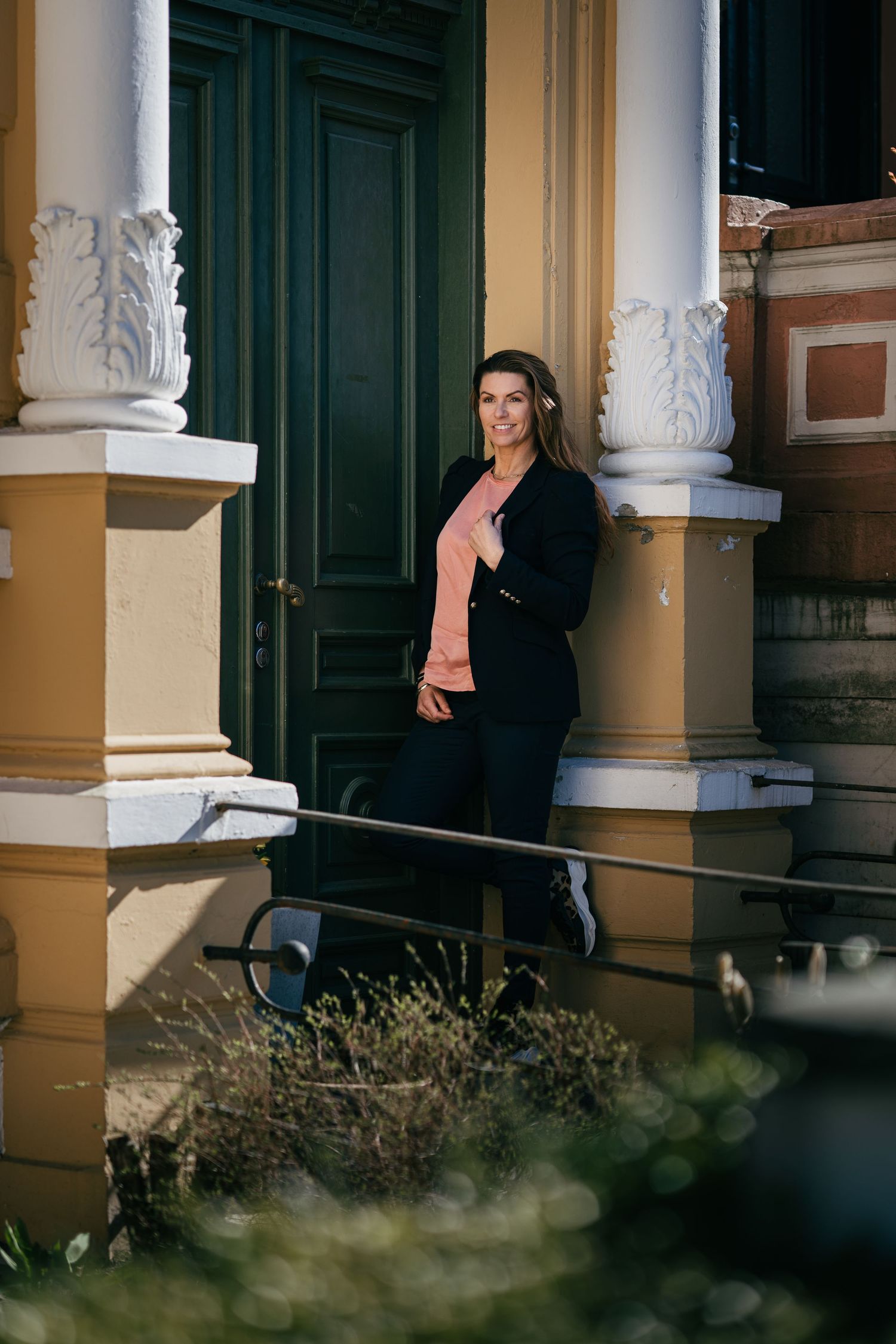 Architectural detail shots of historic building with ornate columns and dark doors.