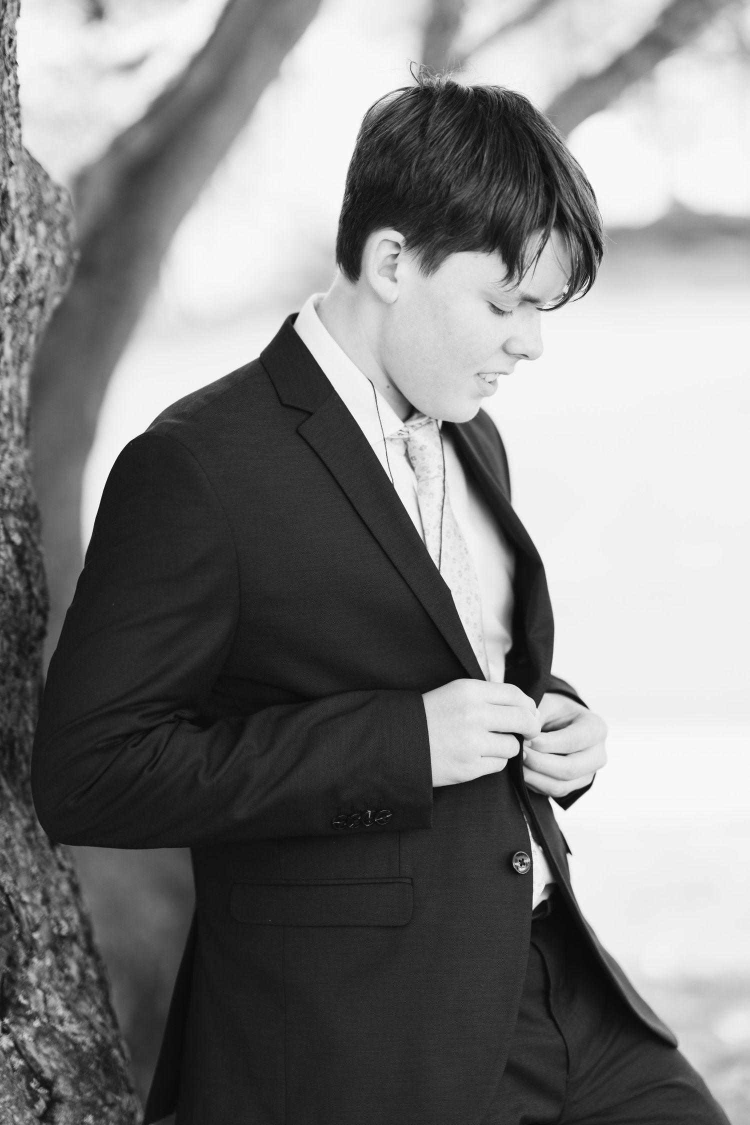Black and white photography of formal poses against a bright background.