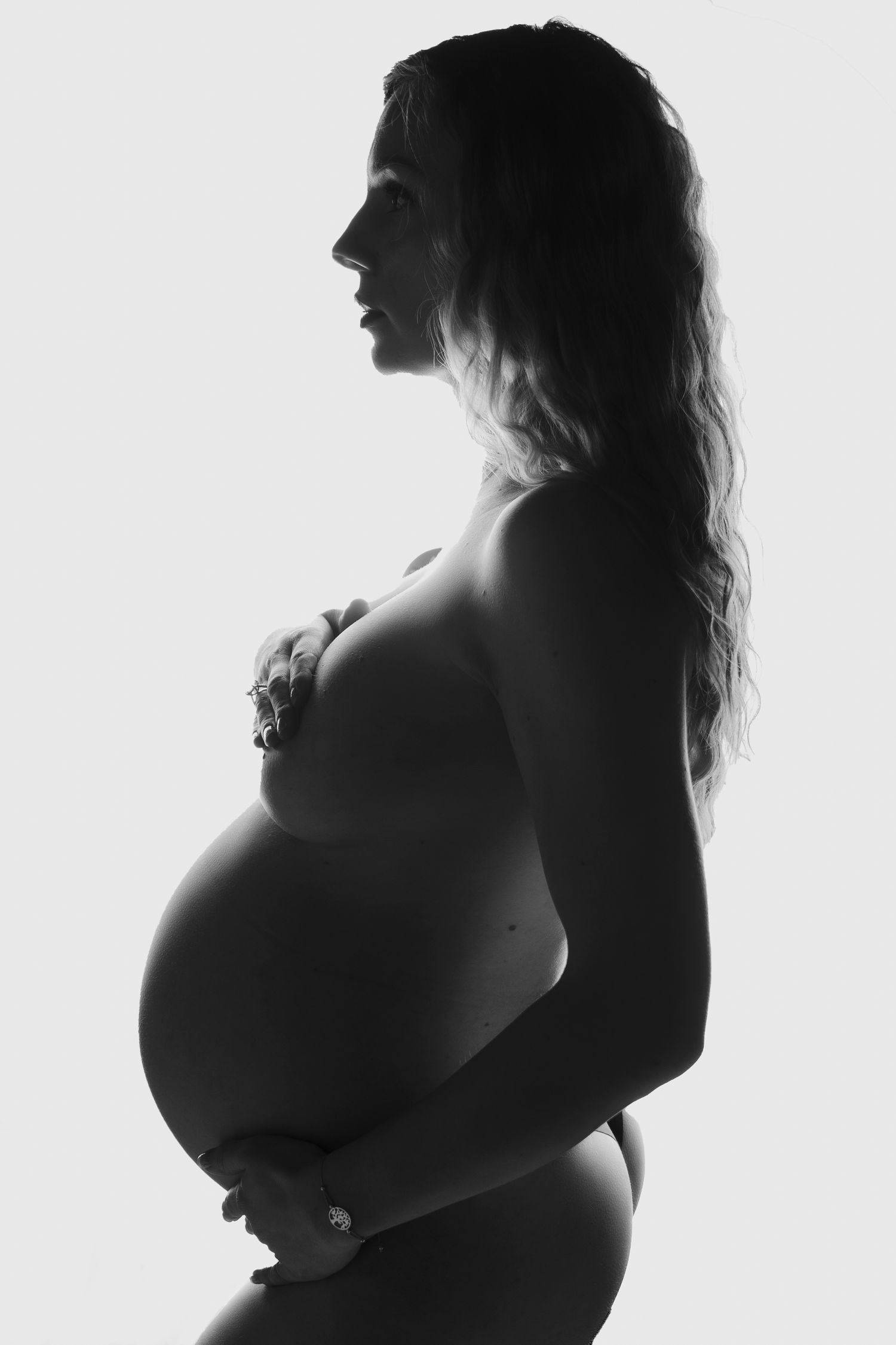 Minimalist black and white maternity portraits capturing the beauty of pregnancy.