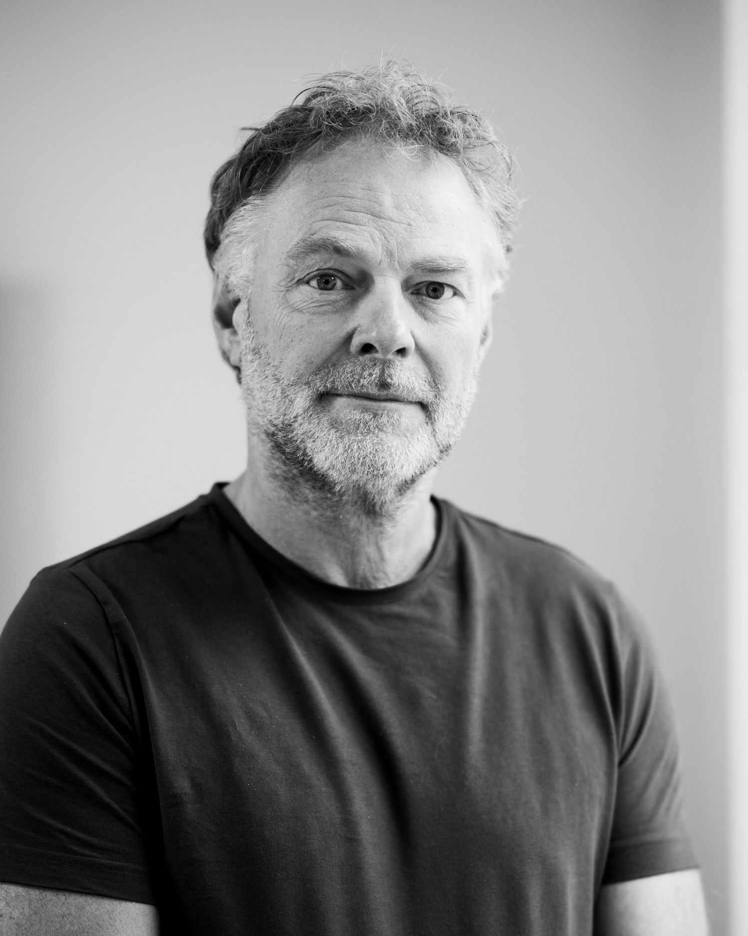 Black and white portrait of a person wearing a dark t-shirt.