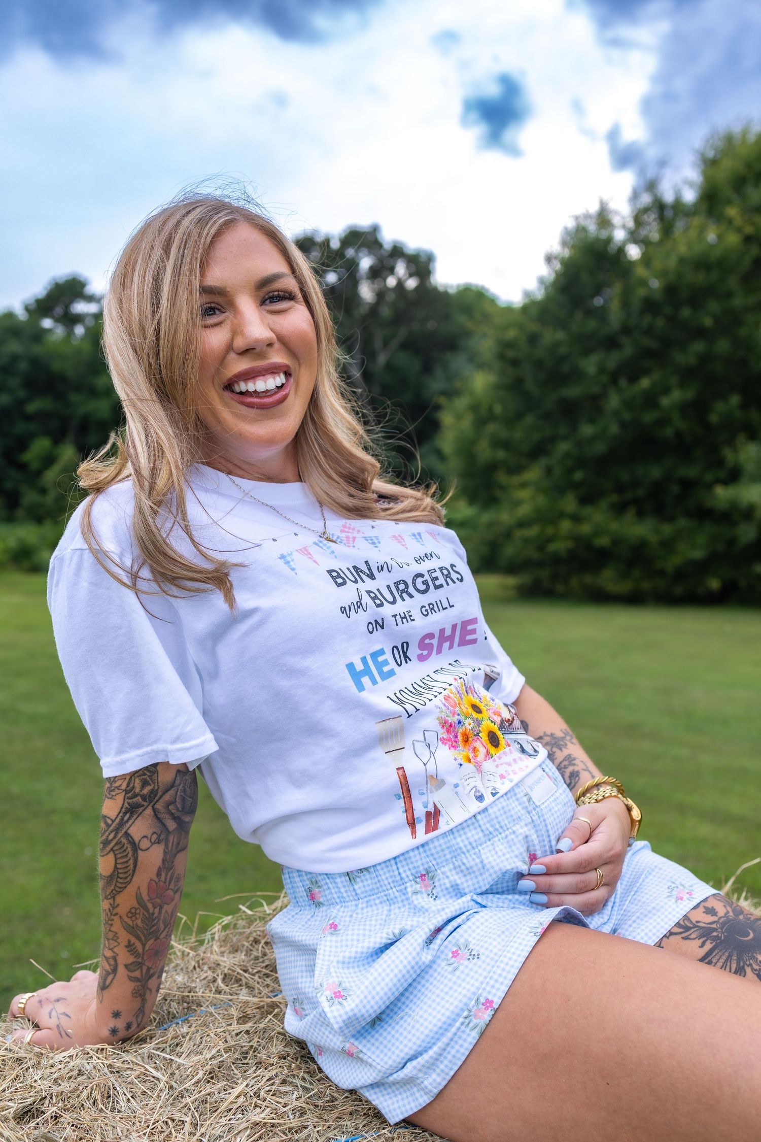 Expecting mother smiling outdoors during a natural maternity photography session in Huntsville, Alabama.