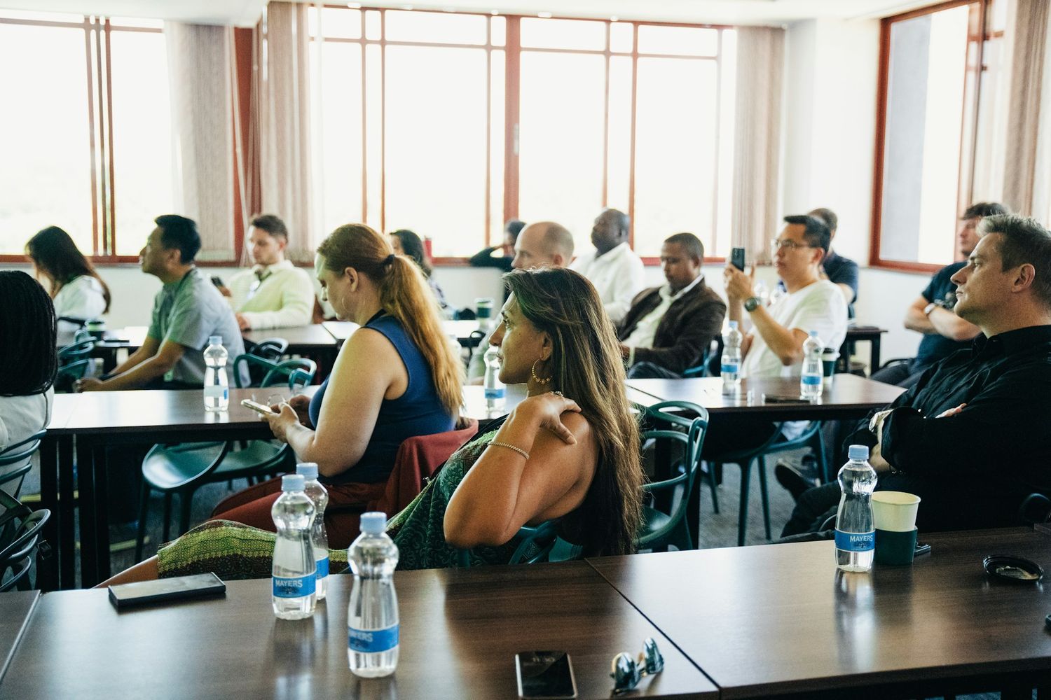 Business and event photography showing attendees at a professional conference or seminar.
