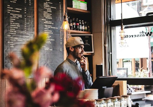 Business branding photography featuring a coffee shop employee working behind the counter.