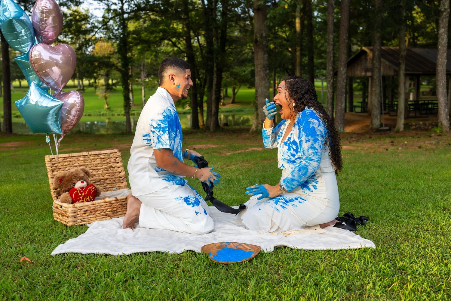 Couple celebrating during an outdoor gender reveal photography session in Huntsville, Alabama