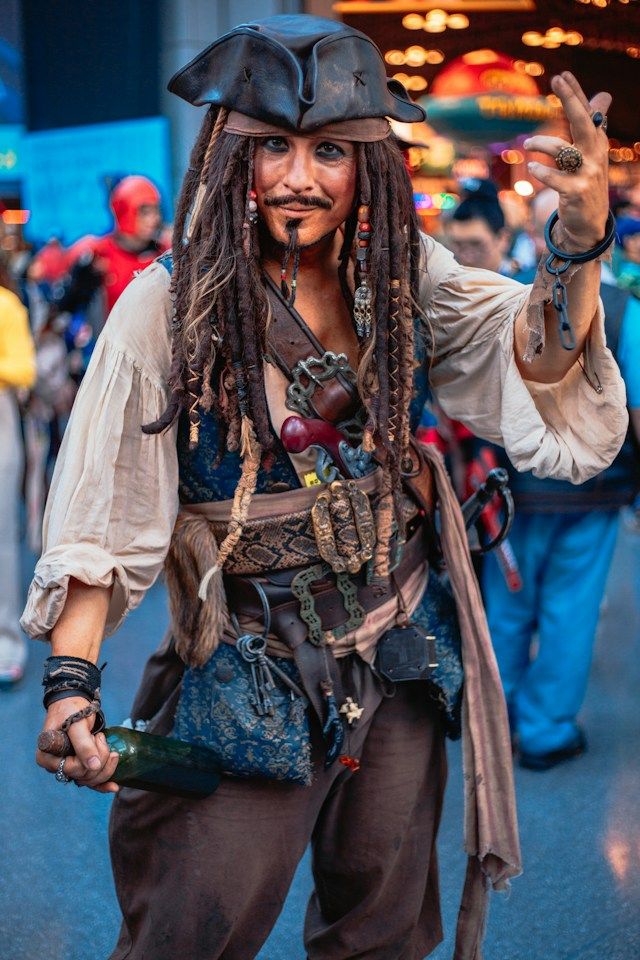 Event photography featuring a pirate-costumed performer interacting with guests at a themed entertainment event.