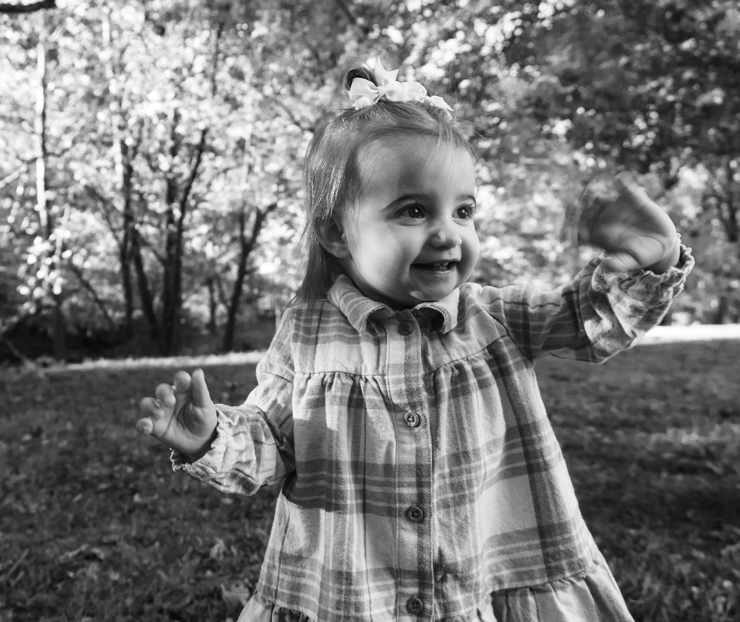 Black and white portrait series of child in plaid shirt.