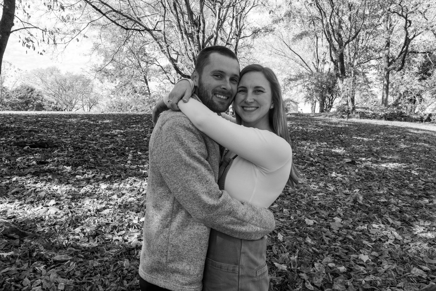 Black and white photo series of a couple embracing in a natural outdoor setting.