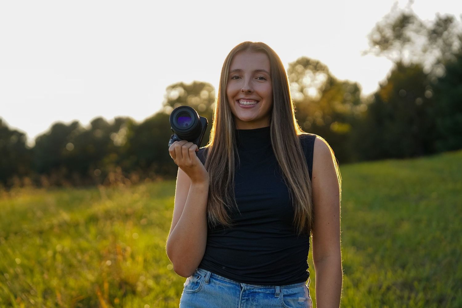 Senior portrait session in golden evening light outdoors.