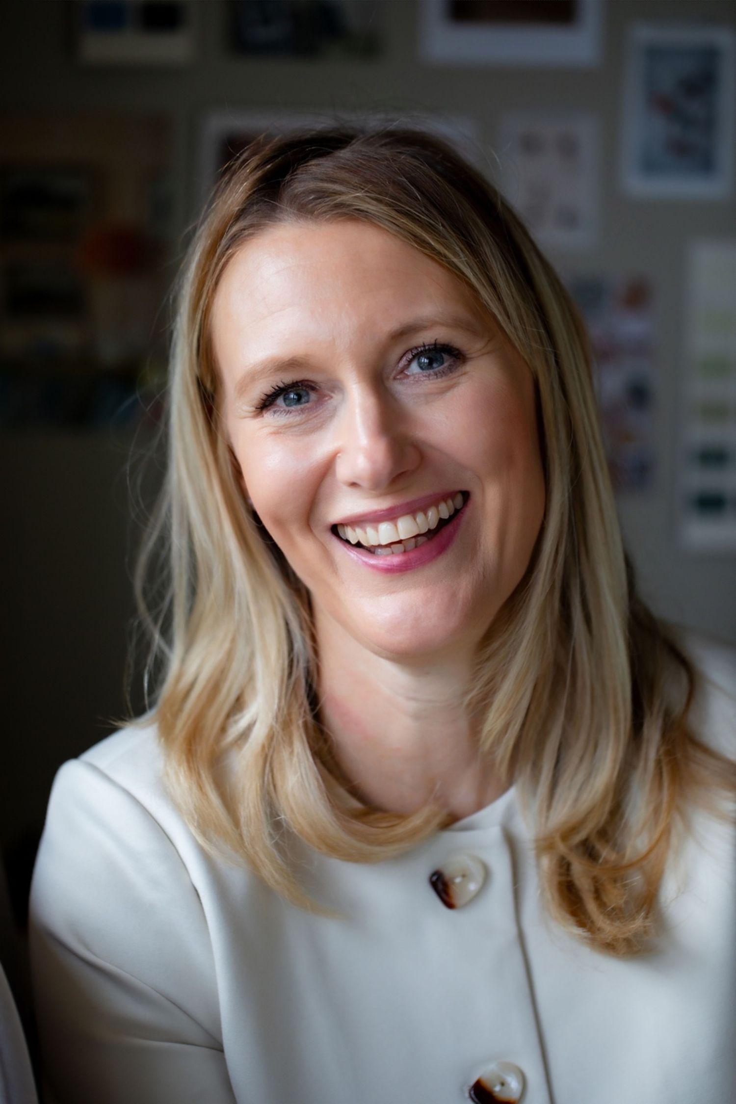 A series of headshots showing someone with blonde hair wearing a white sweater smiling at the camera.