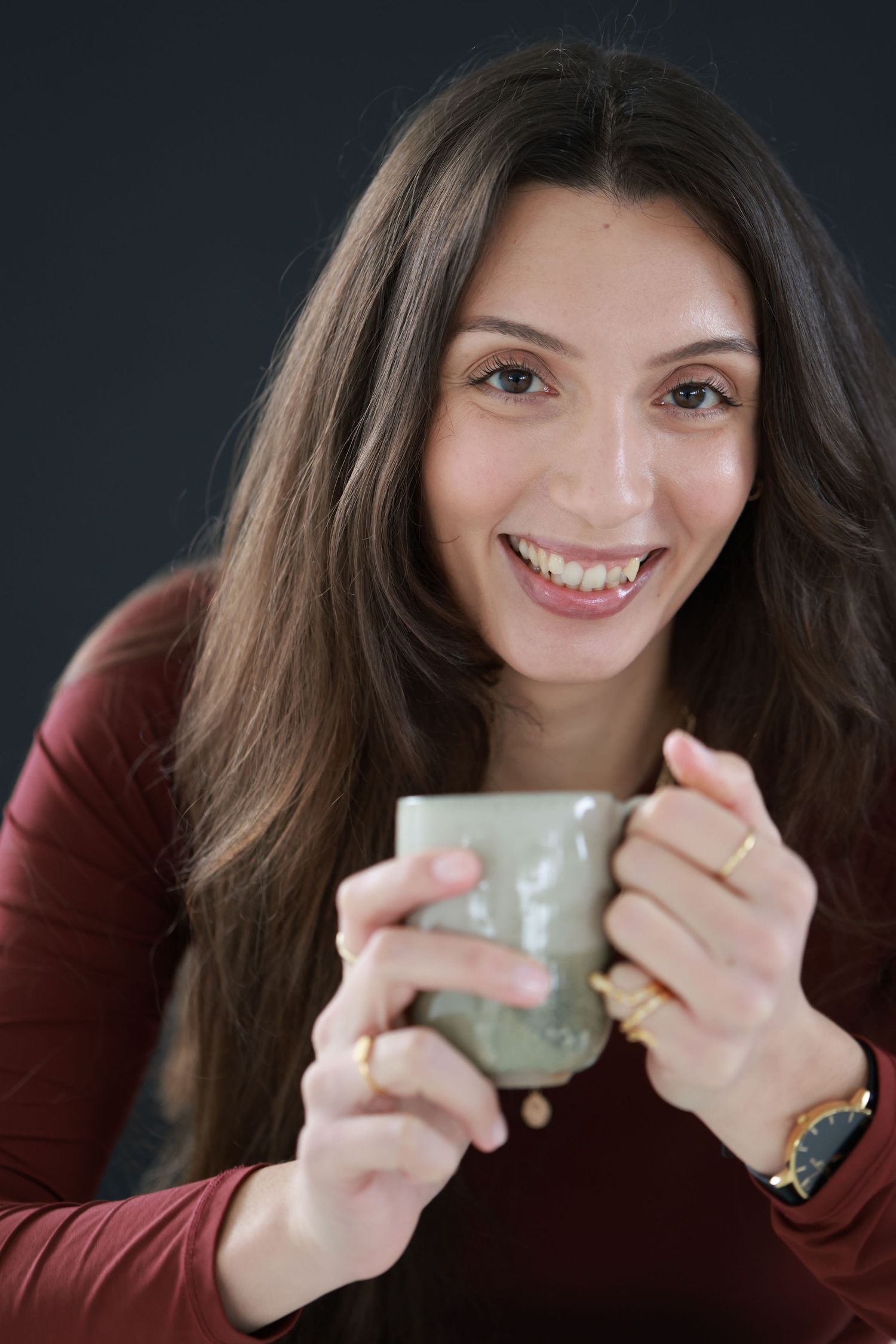 Sequence of photos showing someone with long dark hair smiling and drinking from a gray mug against a black background.