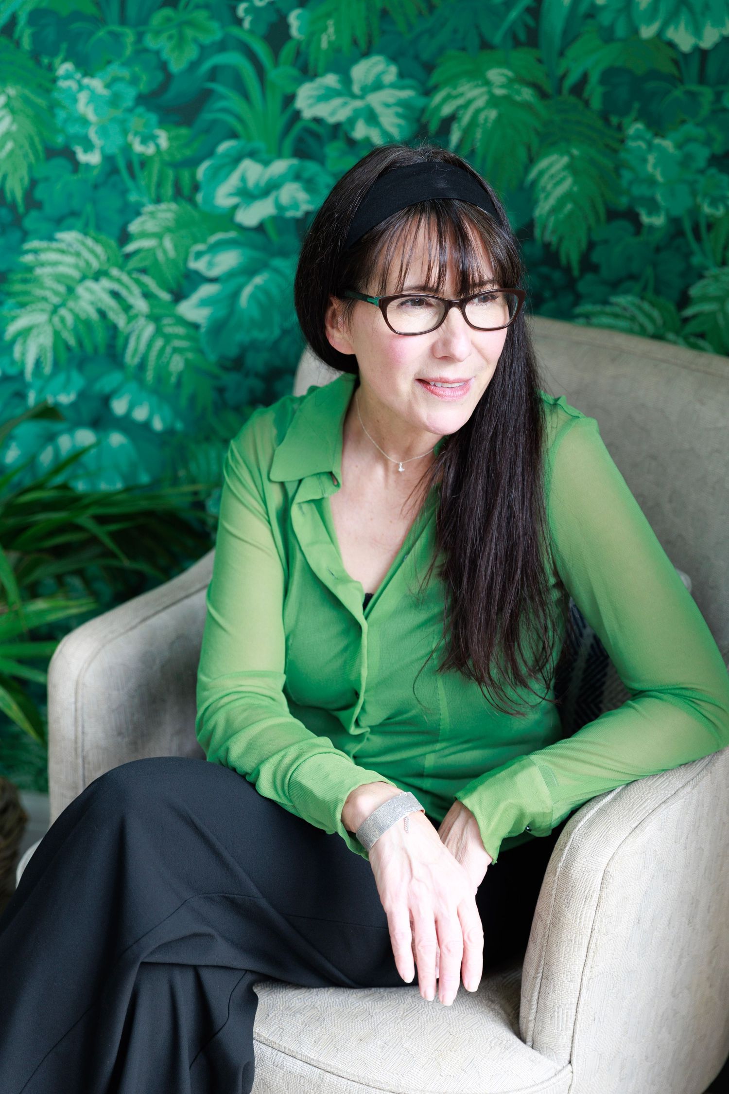 A series of photos showing someone in a bright green blouse seated in a beige armchair against lush green foliage.