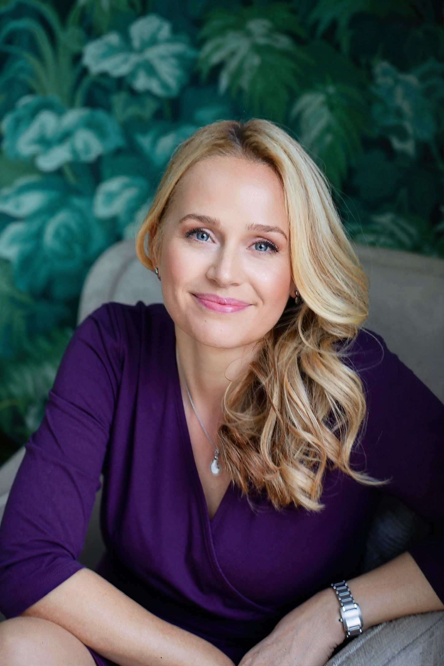 Professional portrait series showing a person in a purple top against a green foliage background in soft lighting.