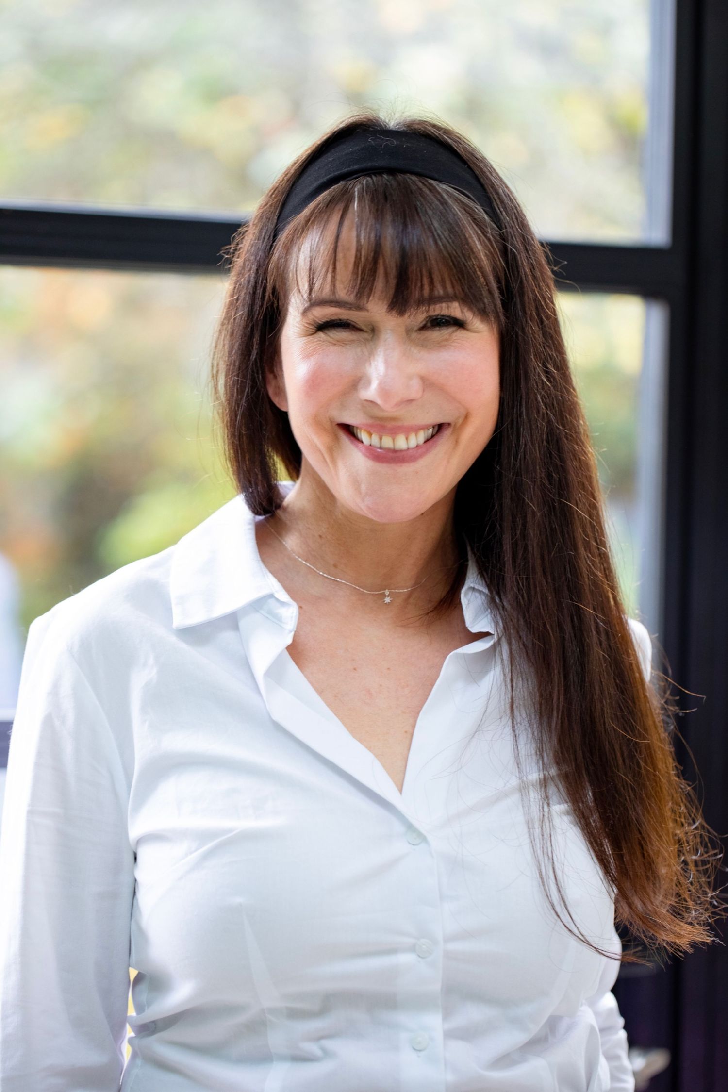 Professional headshot series showing a person in a crisp white collared shirt against a bright window background.