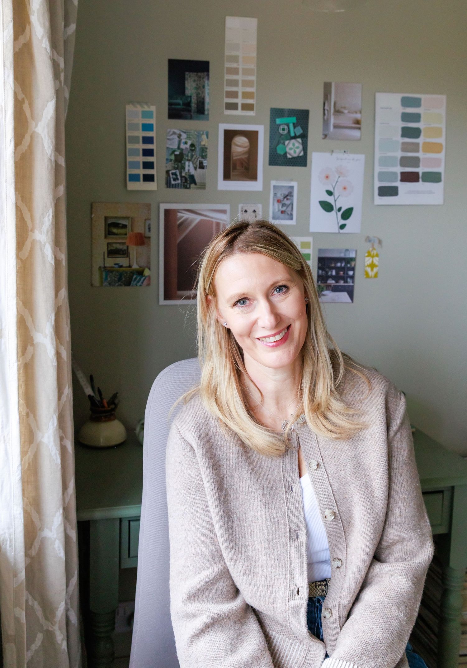 A series of five similar photos showing someone in a beige sweater sitting in front of a wall with photos and papers.