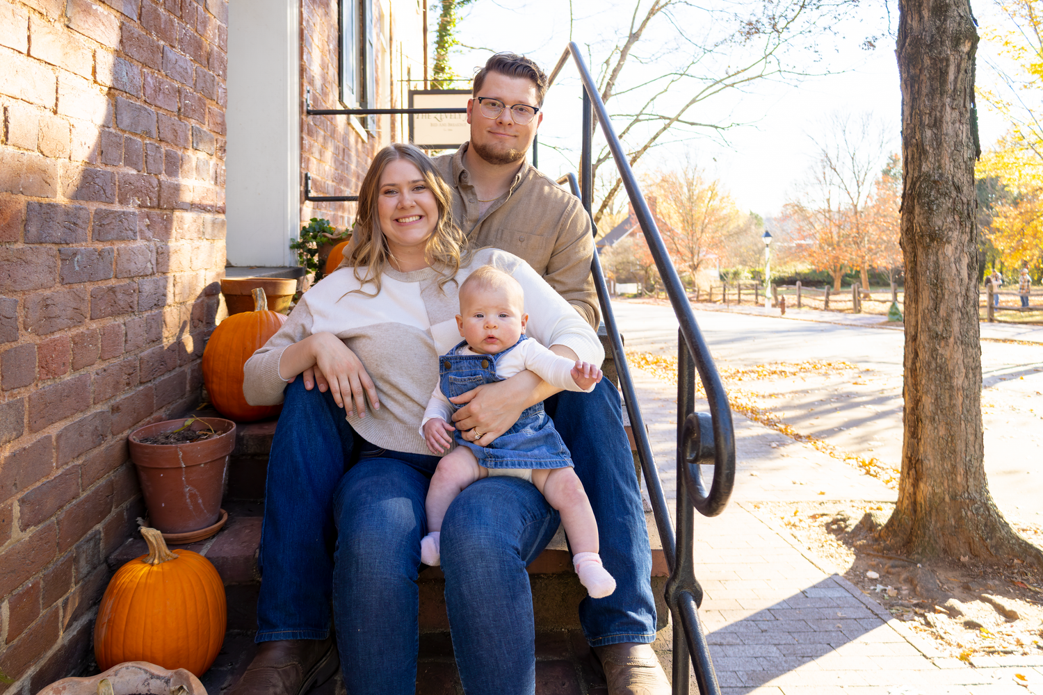 Casual outdoor family photos on brick steps with autumn pumpkins at Old Salem.