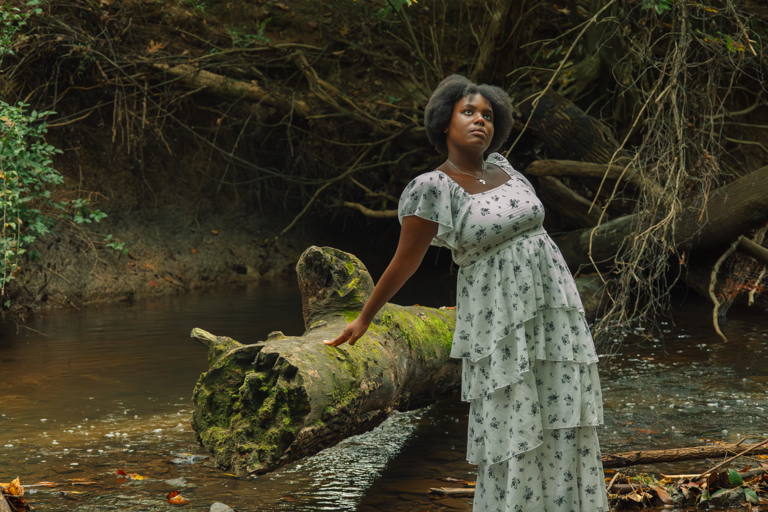 Portrait session in natural forest setting with flowing white dress.