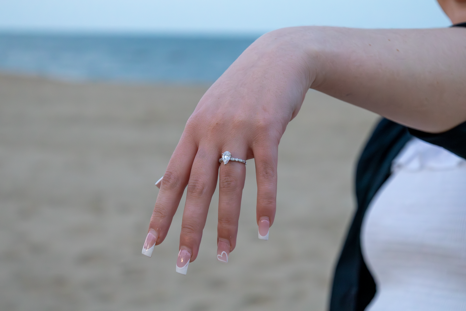 A close-up shot of hands showing engagement rings at a Virginia Beach setting.