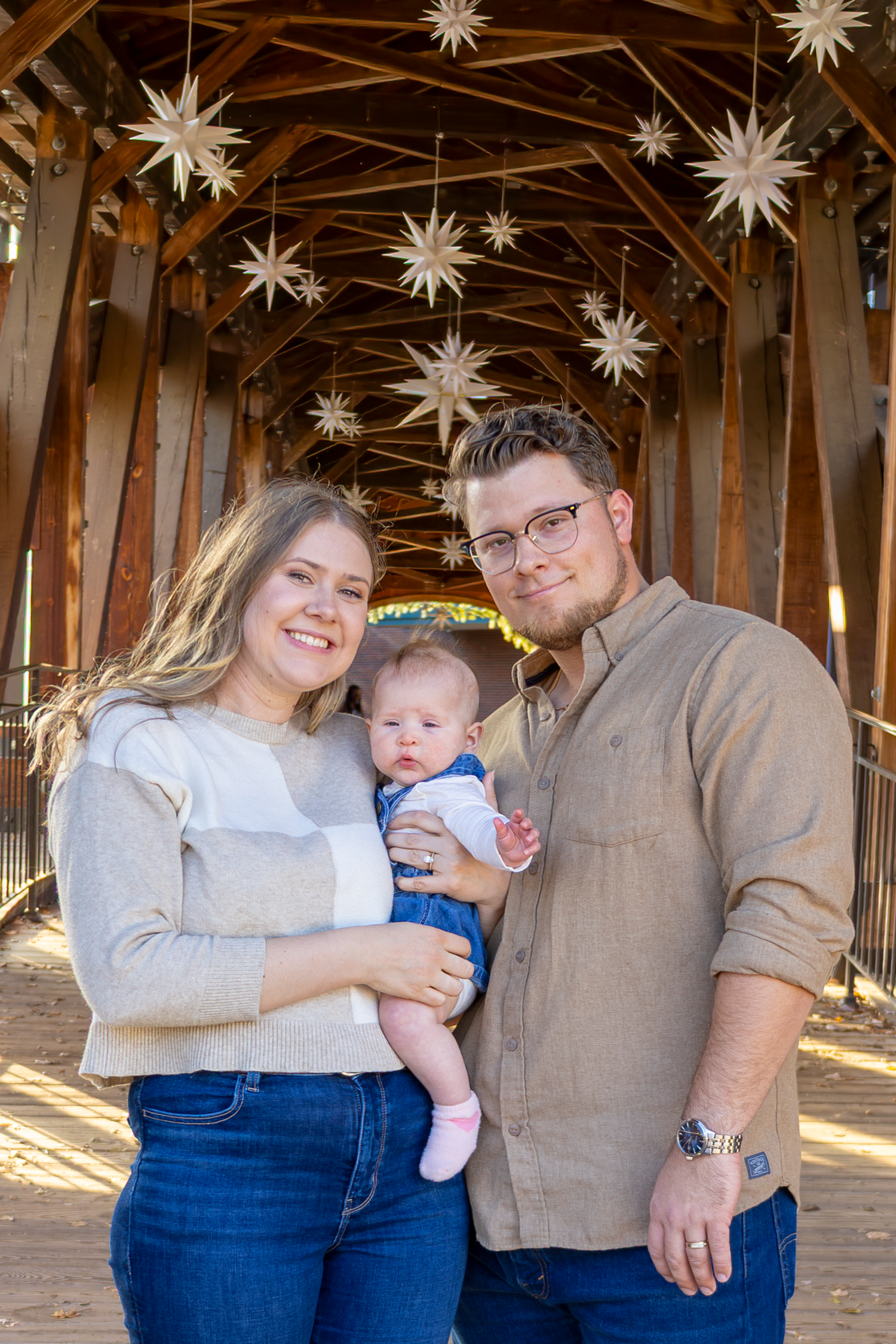 Indoor family photo session with hanging star decorations and warm lighting at Old Salem.