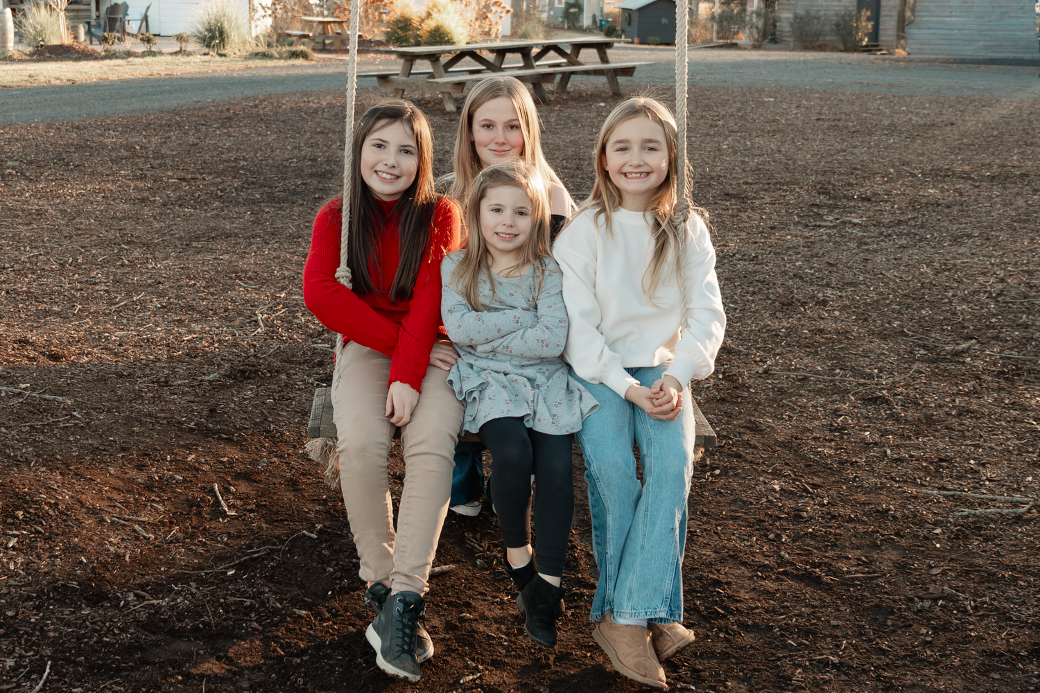 Casual outdoor family portrait taken during golden hour in autumn at Oak Leaf Acres Farm.