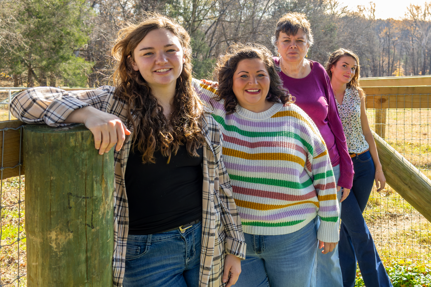 Casual group photo on wooden deck with autumn trees in background at Cedar Rock Park.