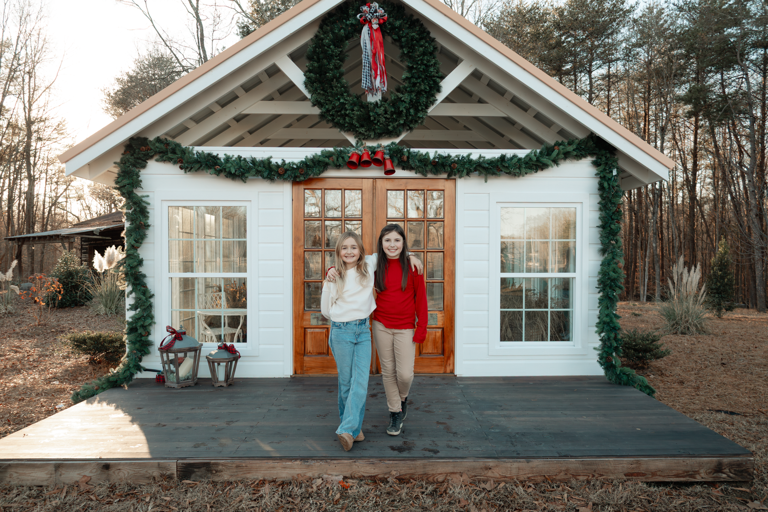 White church building exterior decorated with holiday greenery and red bows at Oak Leaf Acres Farm.