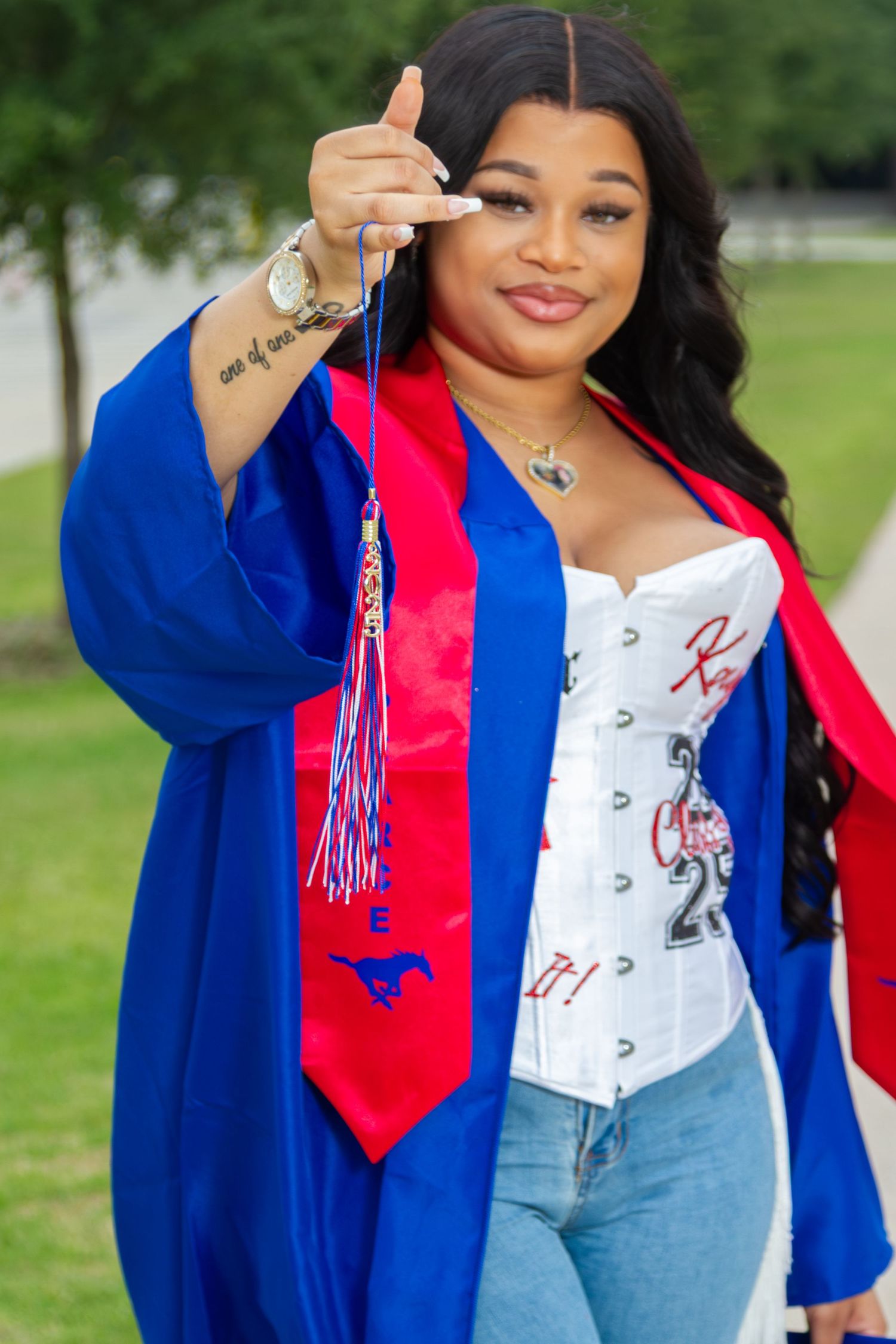 Studio Mari DFW graduation photographer — confident college graduate downtown urban portrait serving Rockwall Mesquite Dallas Fort Worth TX