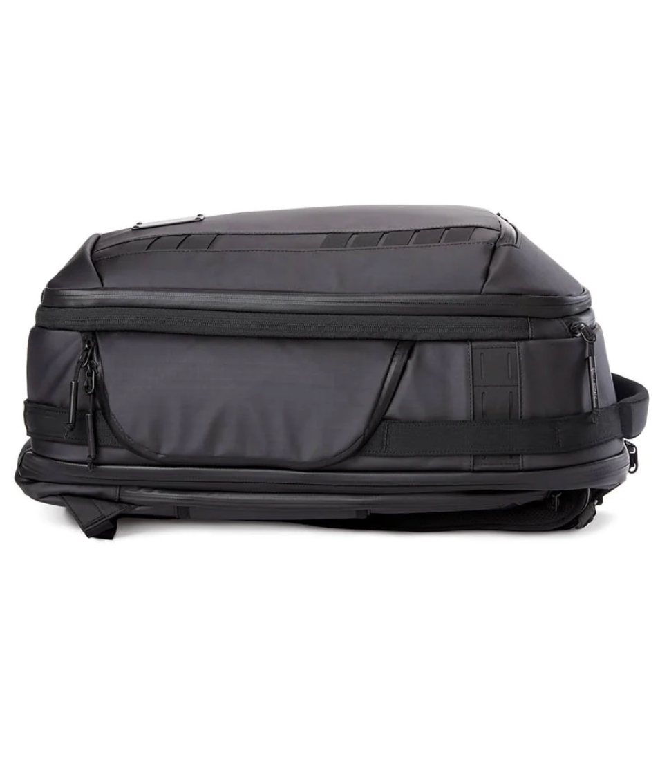 Side view of grey professional camera backpack with multiple storage compartments.
