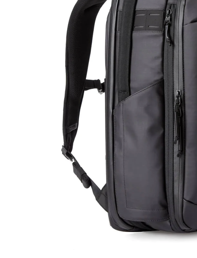 Close-up view of black backpack shoulder strap and side panel showing durable construction and padding.