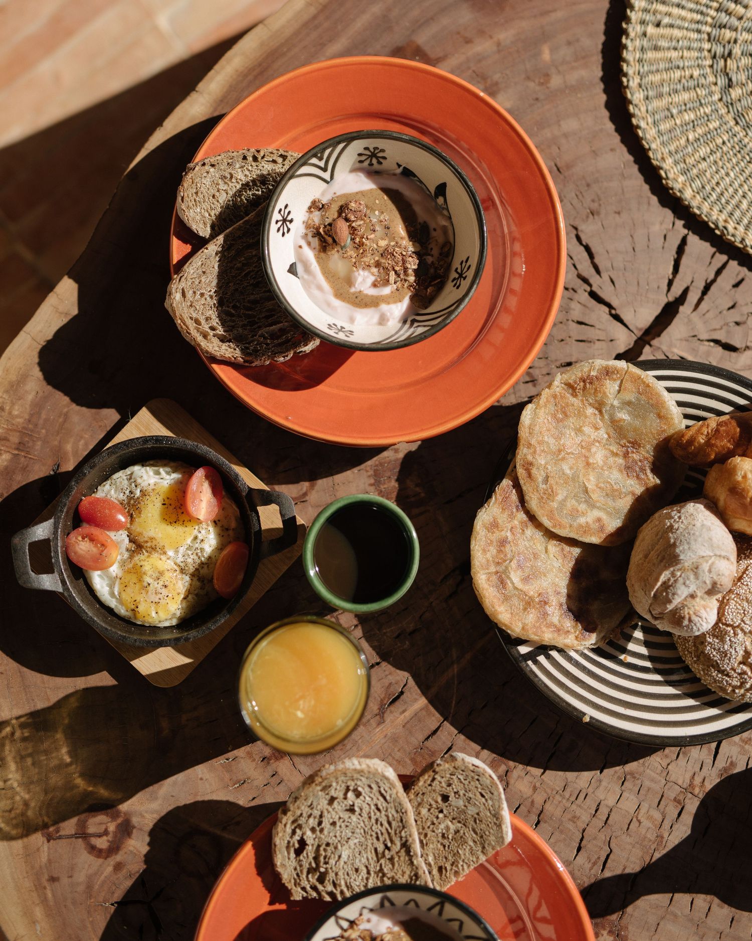 Multiple overhead shots of breakfast spreads with coffee, pastries, and drinks on rustic surfaces in warm morning light.