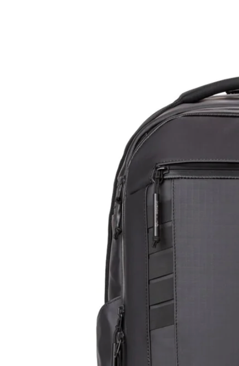 Detail shot of a dark gray backpack showing zippered compartments and organizational features.