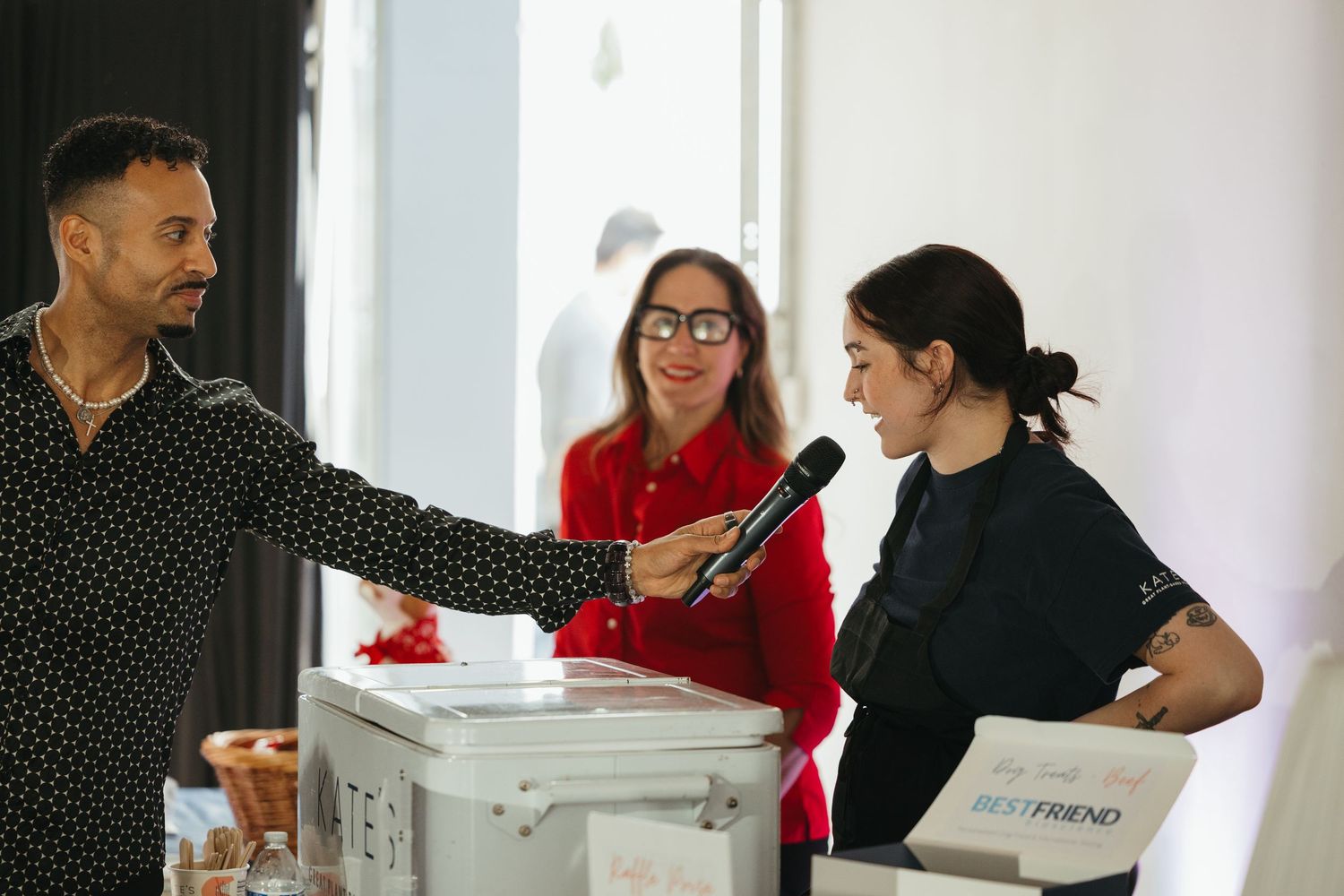 People interacting at registration desk during indoor event.