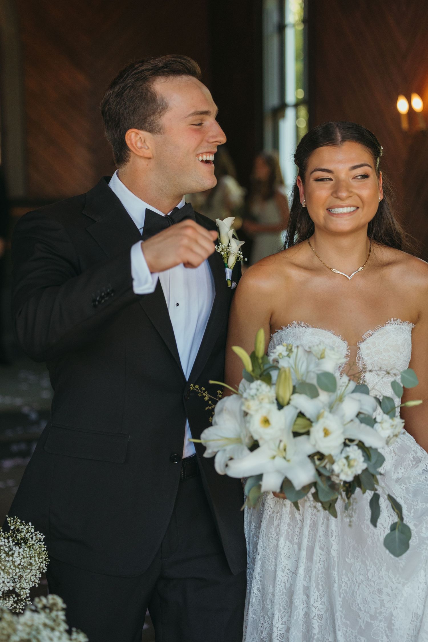Newlyweds share a candid laughing moment during their church ceremony.