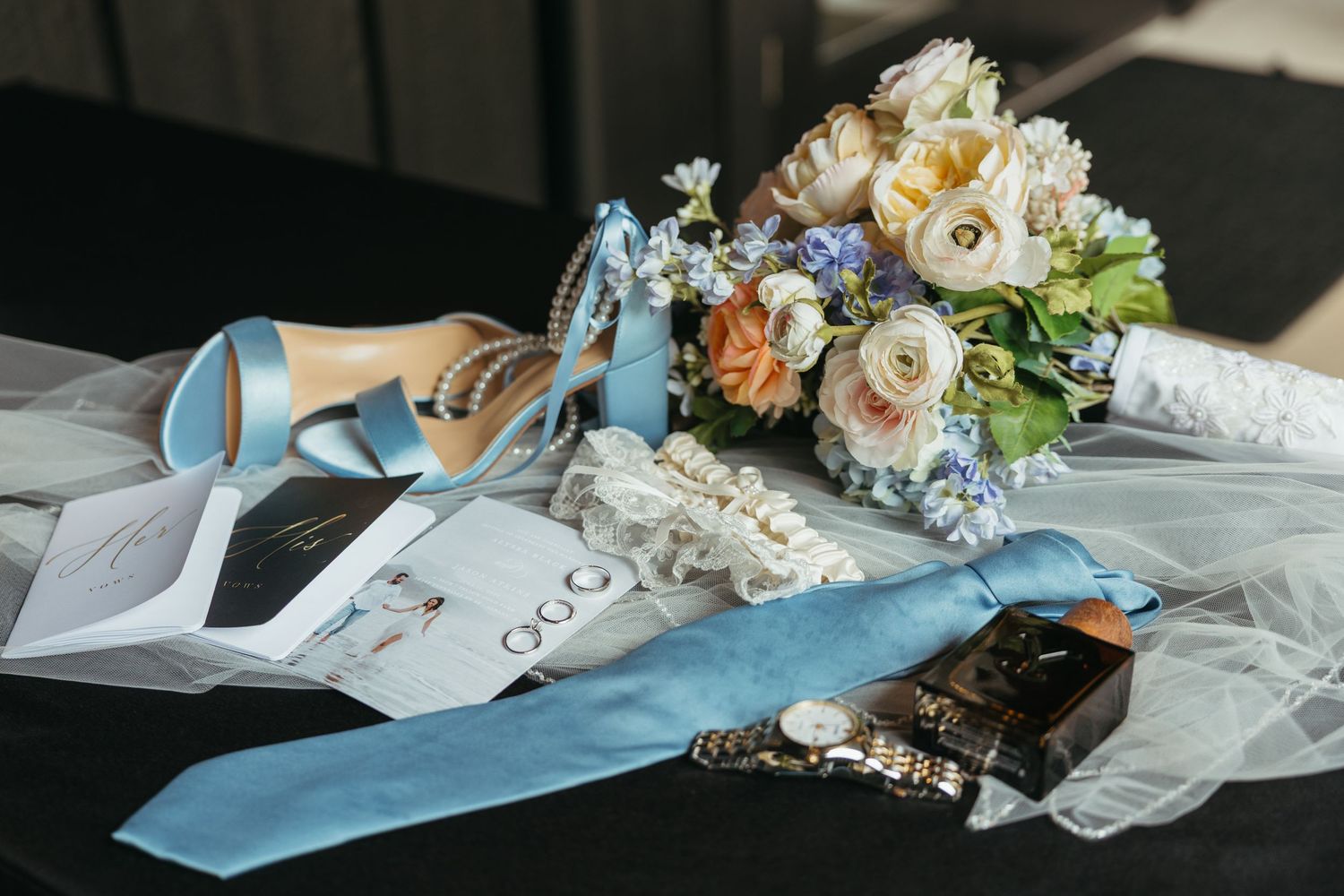 Wedding details featuring blue ribbons and delicate floral arrangements.