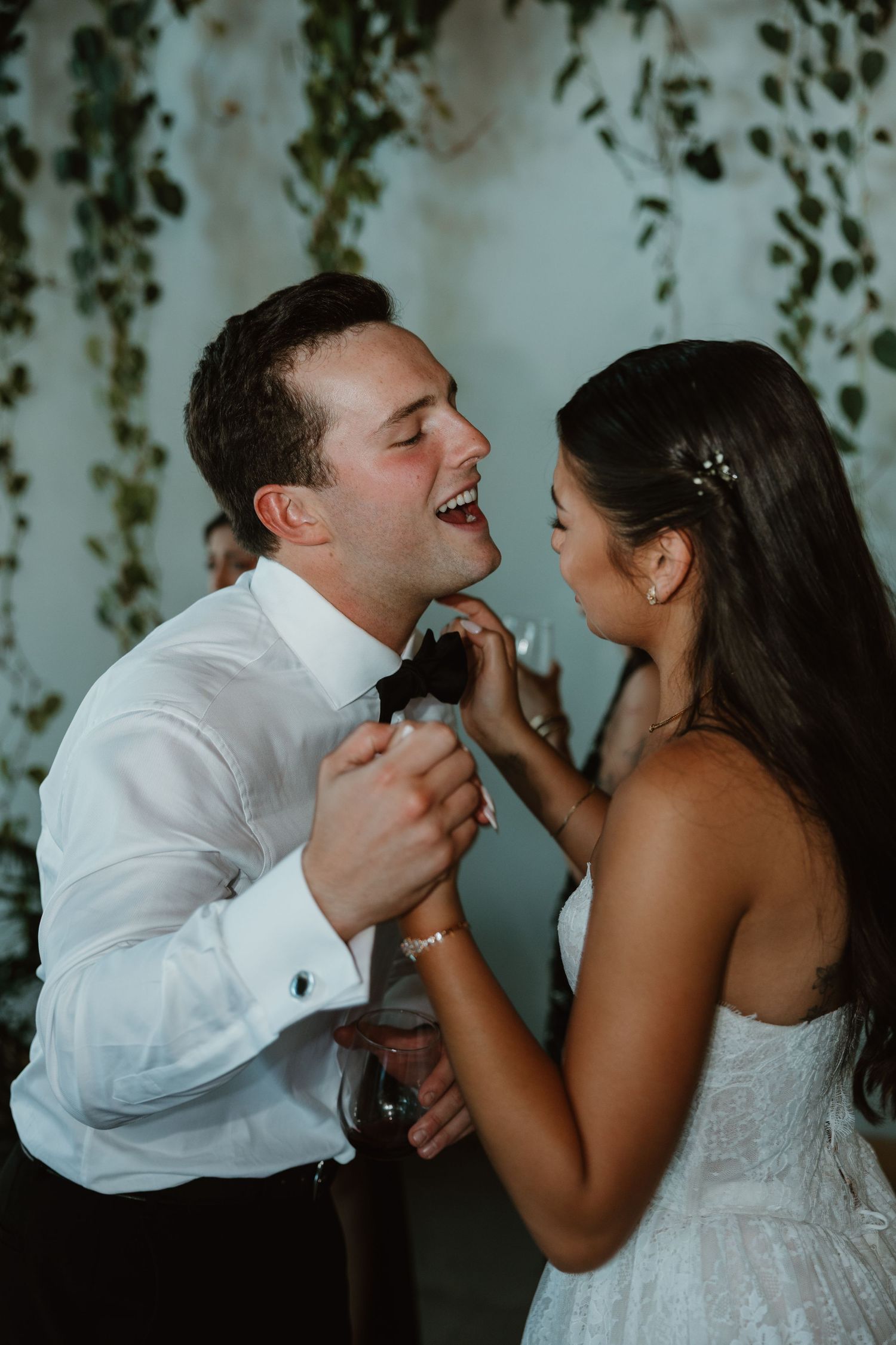 A candid sequence of joyful laughter and playful interaction at a wedding celebration.