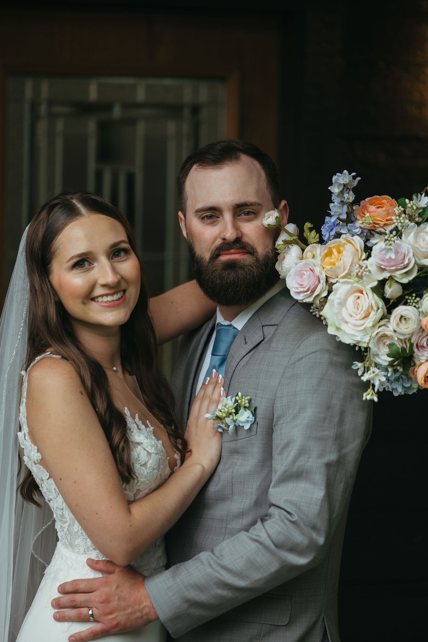 Romantic wedding portrait with soft floral bouquet and elegant details.