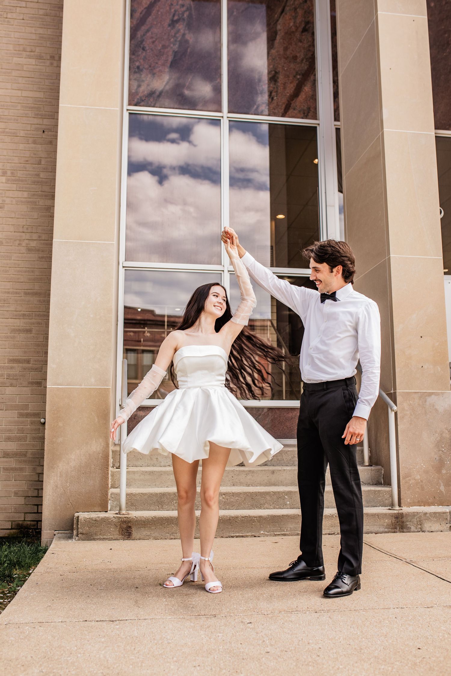Bride and groom dancing for their portraits after saying i do at the beautiful Cass City court house.
