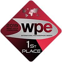 2019 WPE International Photographers Awards 1st Place First Half Competition badge on red and black diamond shape.
