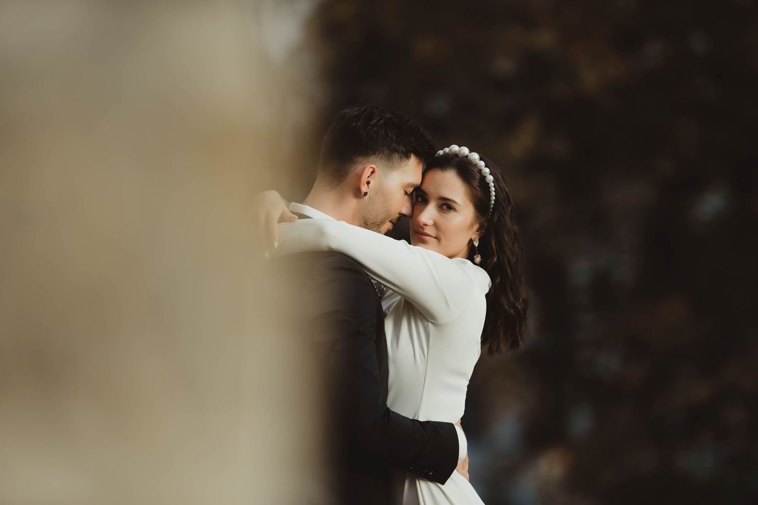 A close-up wedding portrait capturing an intimate dance moment with soft lighting.