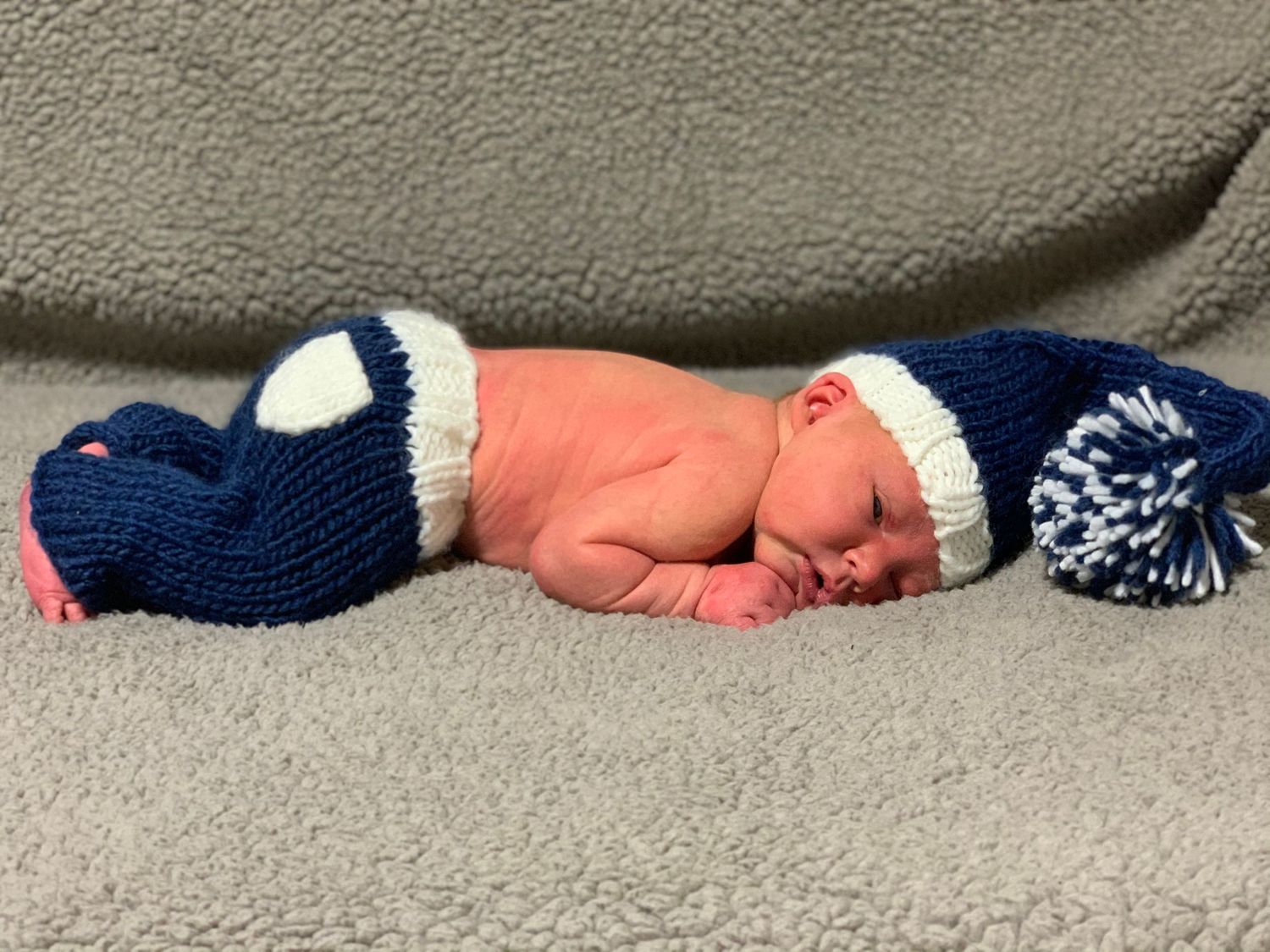 Newborn baby portrait in a navy and white knit outfit