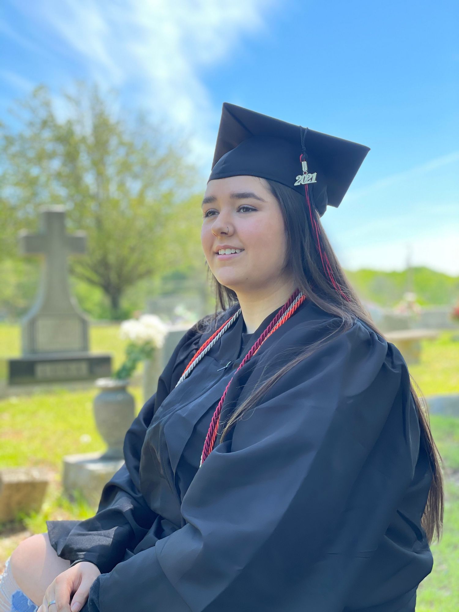 Senior graduation portrait outdoors in cap and gown