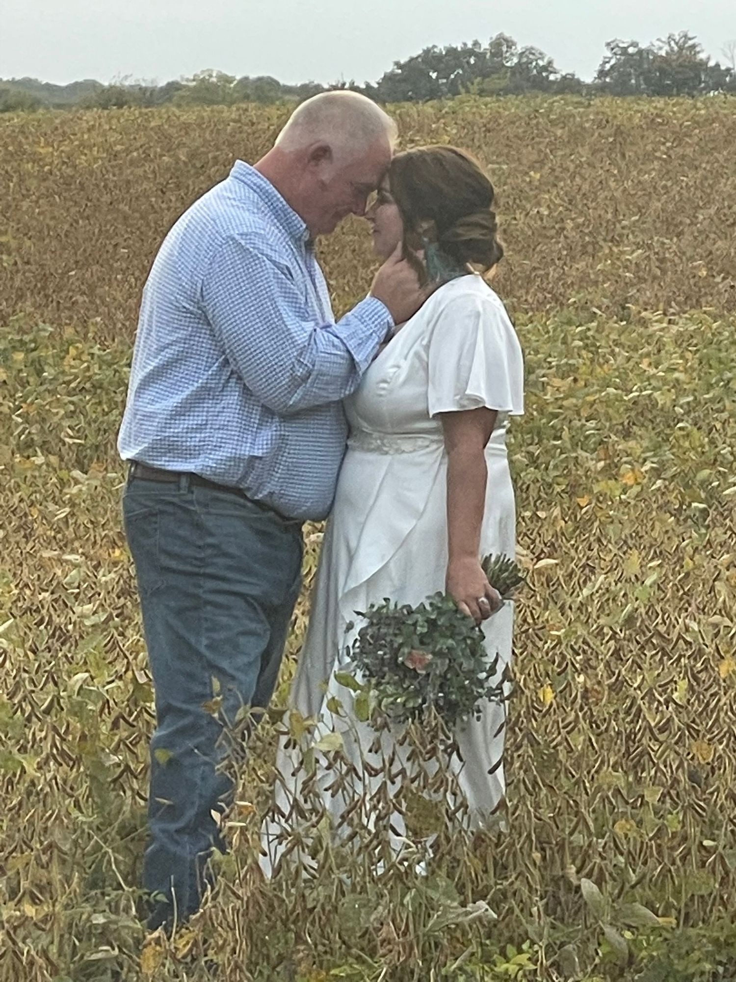 Couples portrait in a country field