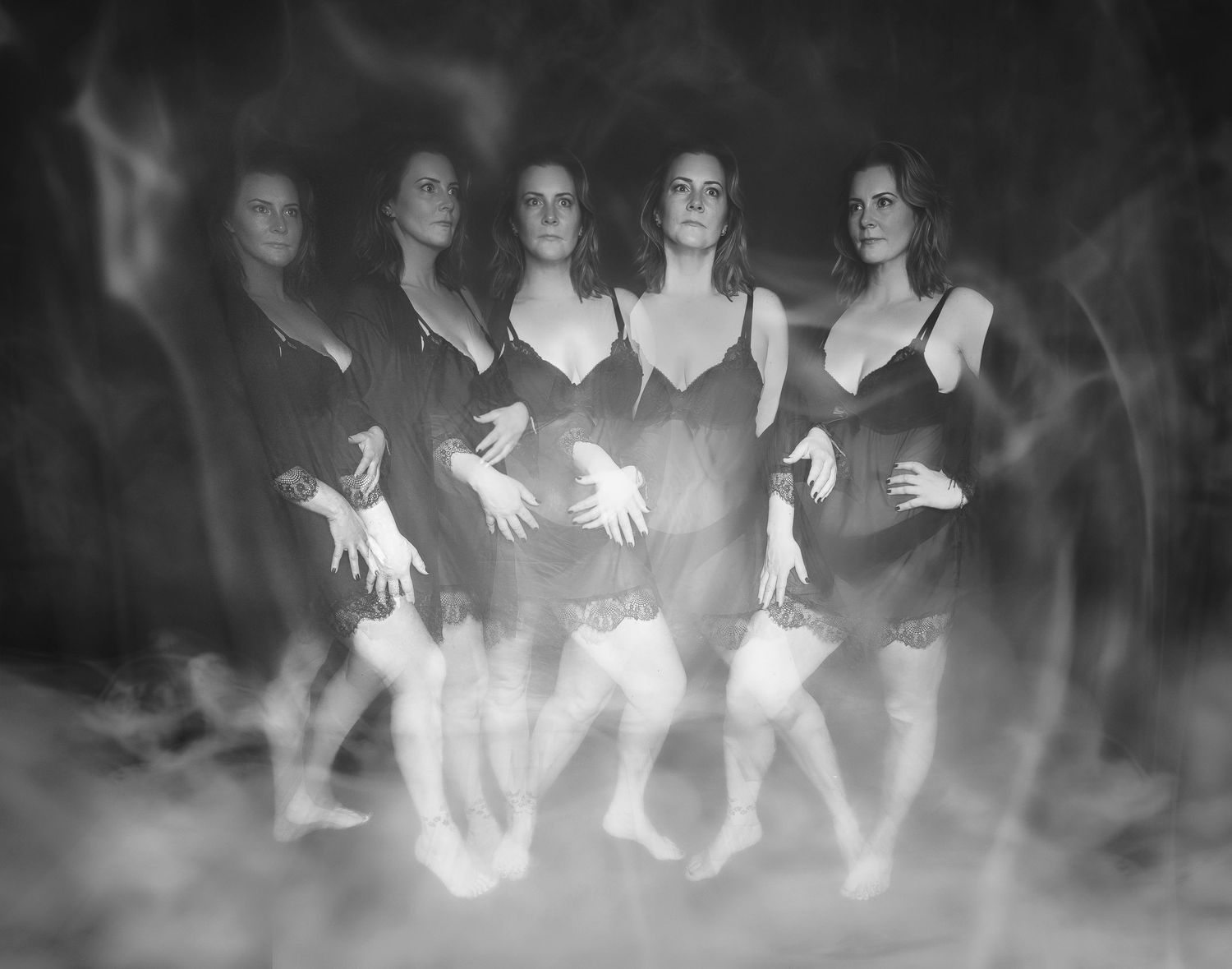 Artistic black and white multiple exposure boudoir portrait showing woman in black lingerie with ghostly effect.