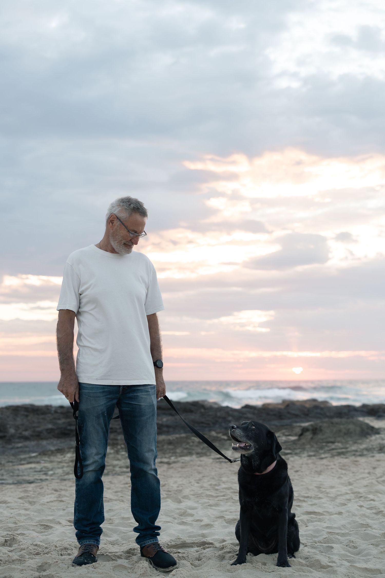 Man and dog at Currumbin Beach during a natural Gold Coast dog photography session