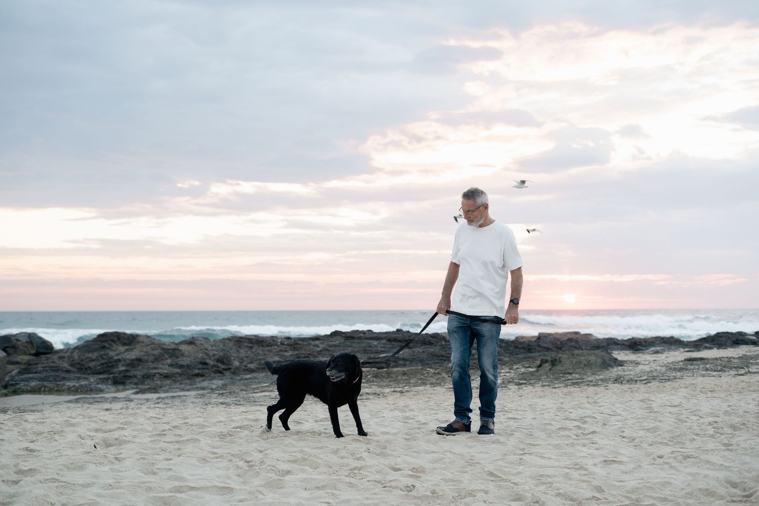 Man and dog at Currumbin Beach during pet photography session