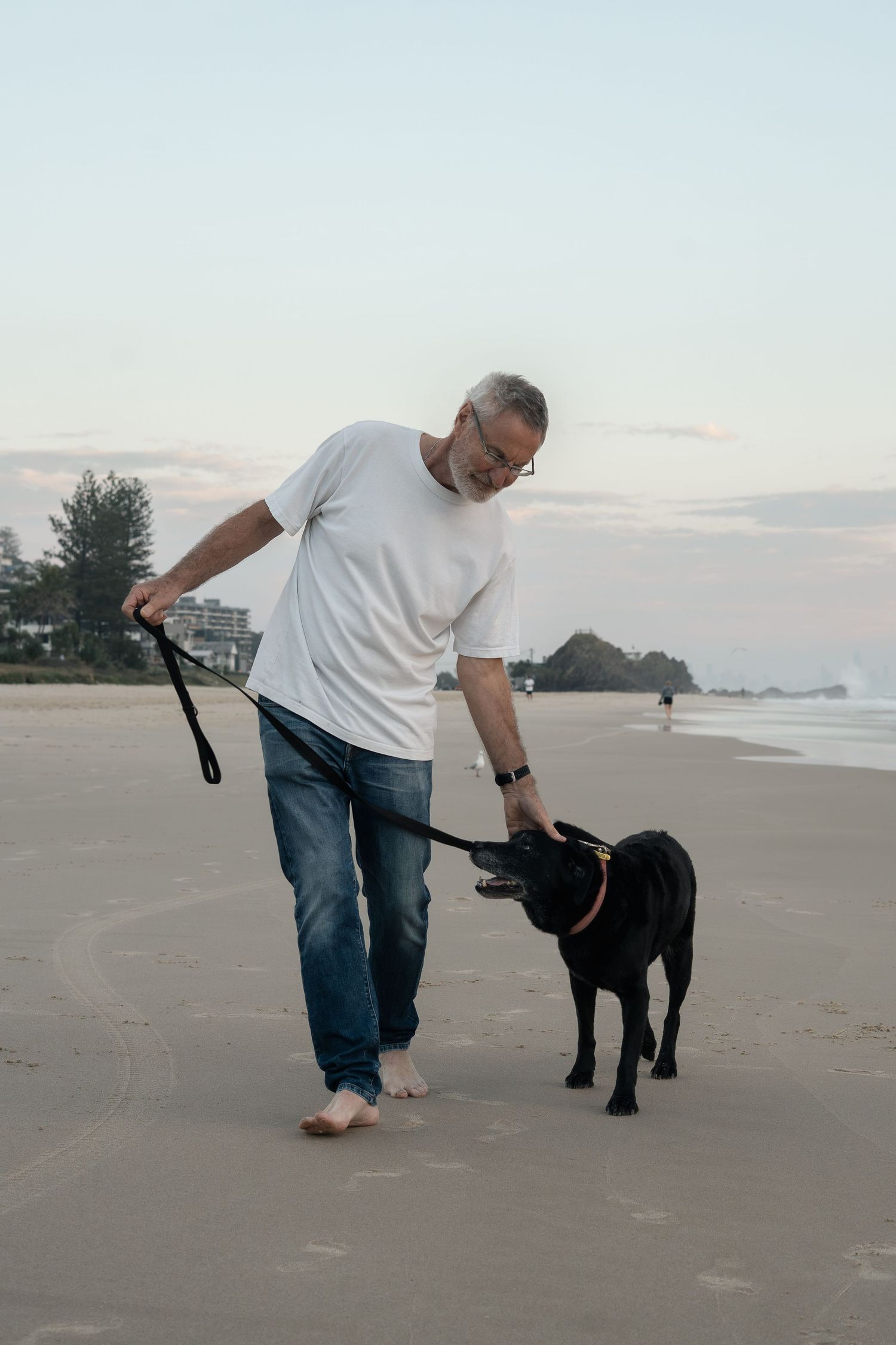 Man and dog at Currumbin Beach during pet photography session