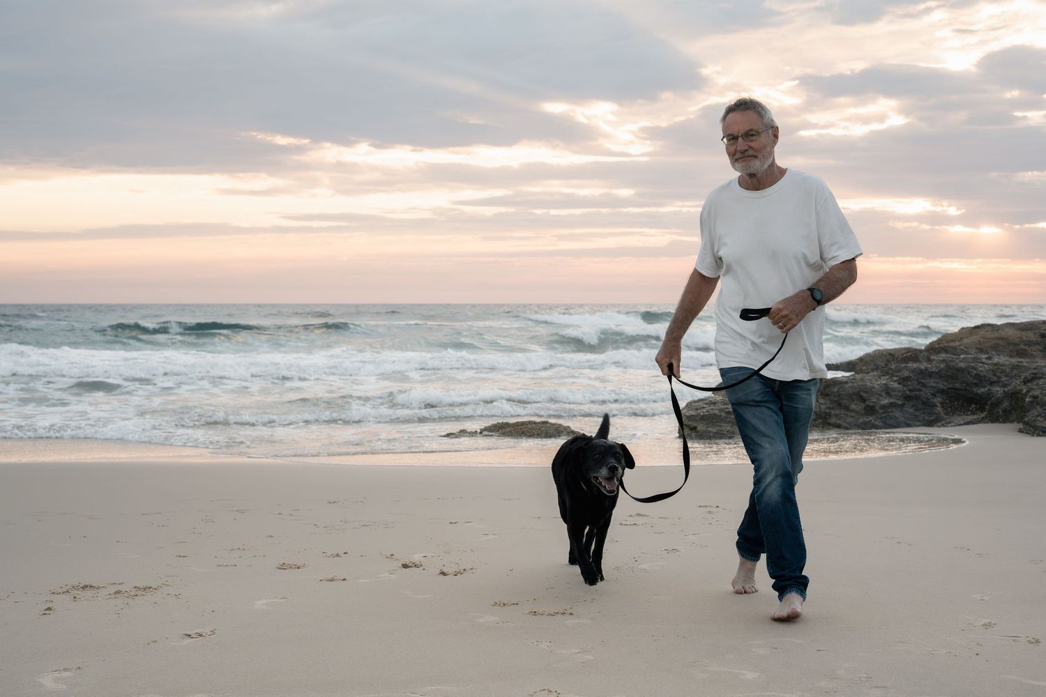 Man and dog at Currumbin Beach during pet photography session