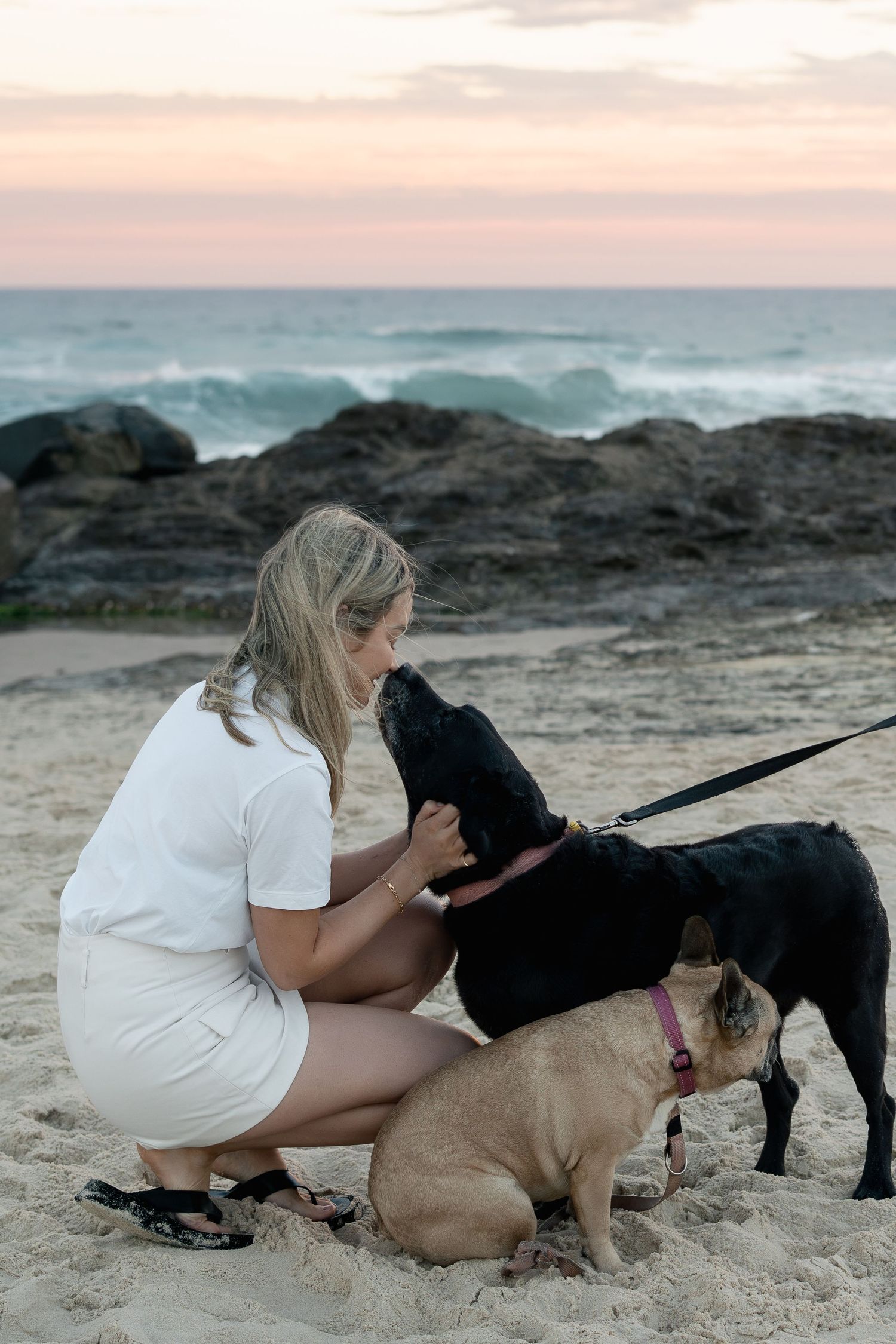 Woman with her dog on the beach during a natural pet photography session on the Gold Coast