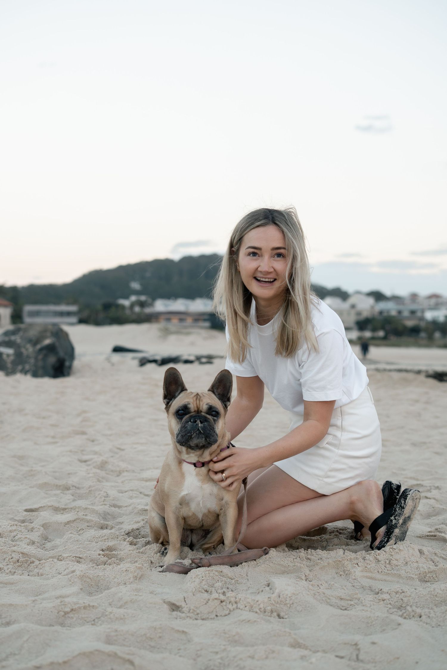 Woman with her dog on the beach during a natural pet photography session on the Gold Coast