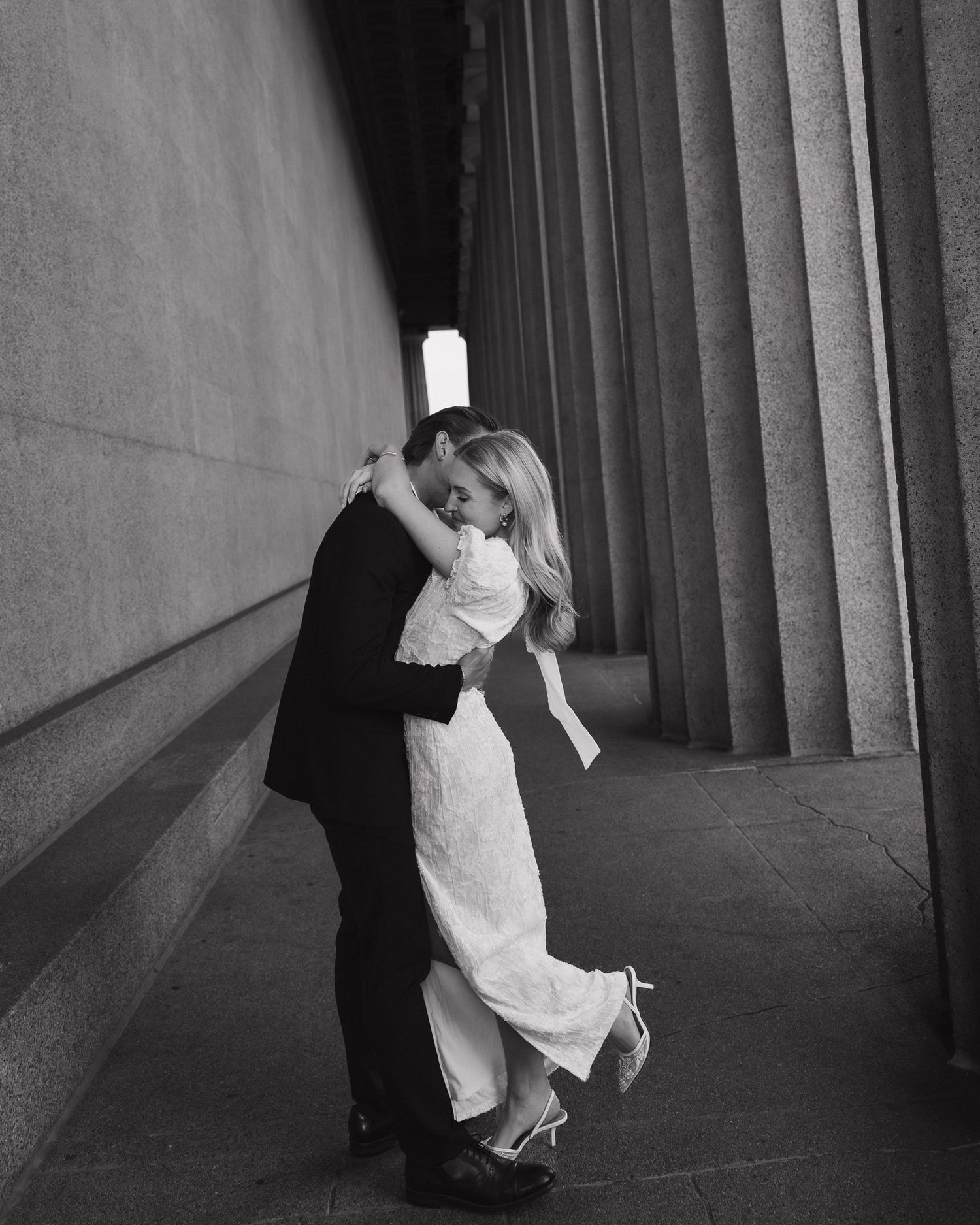 A couple intimately hugging each other and celebrating their engagement.